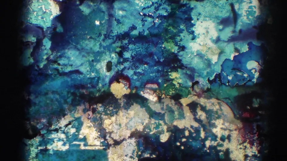 Final 1966 El Monte 8mm frame largely obscured by blue-green film damage, mottling, and color distortion from the aged source reel.