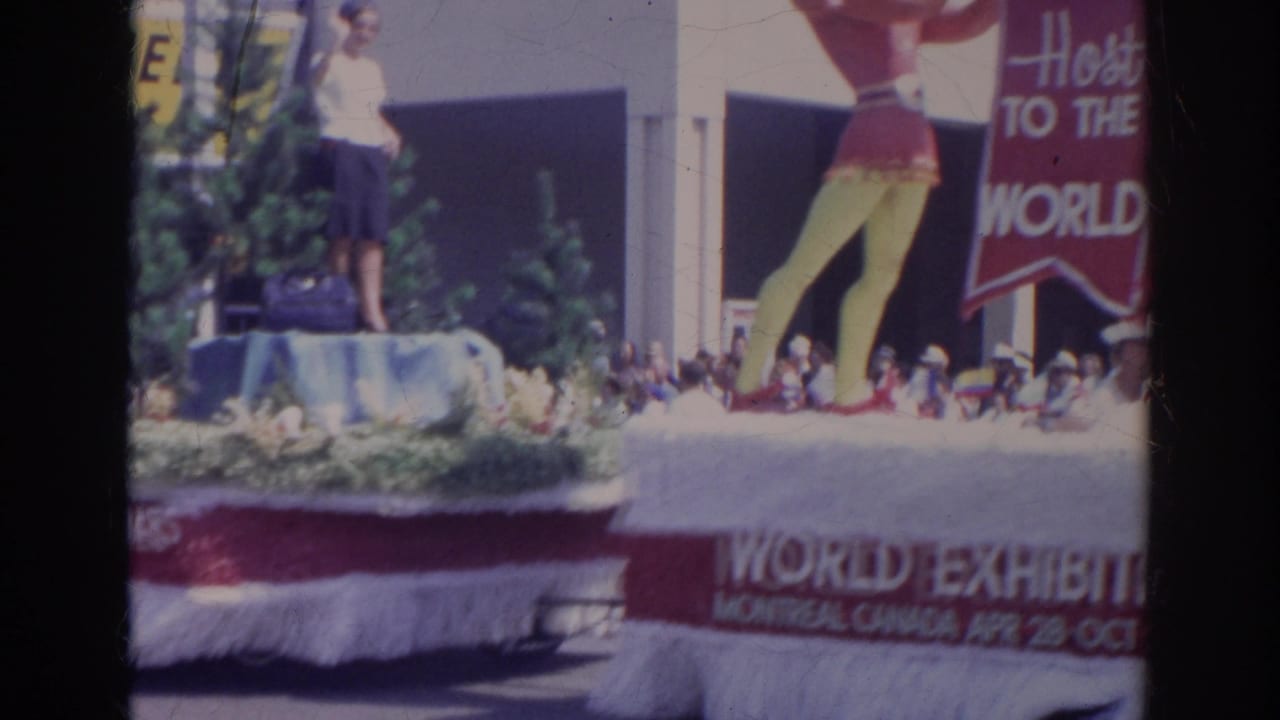 Parade float with trees, a standing person, and Expo 67 Montreal lettering.