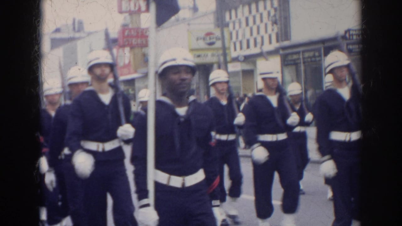 Uniformed Navy sailors march close to the camera in the 1966 Norfolk parade, with storefront signage and spectators in the background.