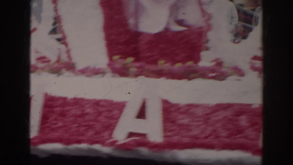 Norfolk, Virginia 1966 parade float detail with pink and white decorations and large partial letters across the side.
