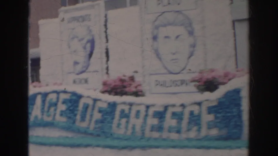 Norfolk 1966 parade float panels show portrait drawings and a blue banner section that appears to read part of “AGE OF GREECE.”