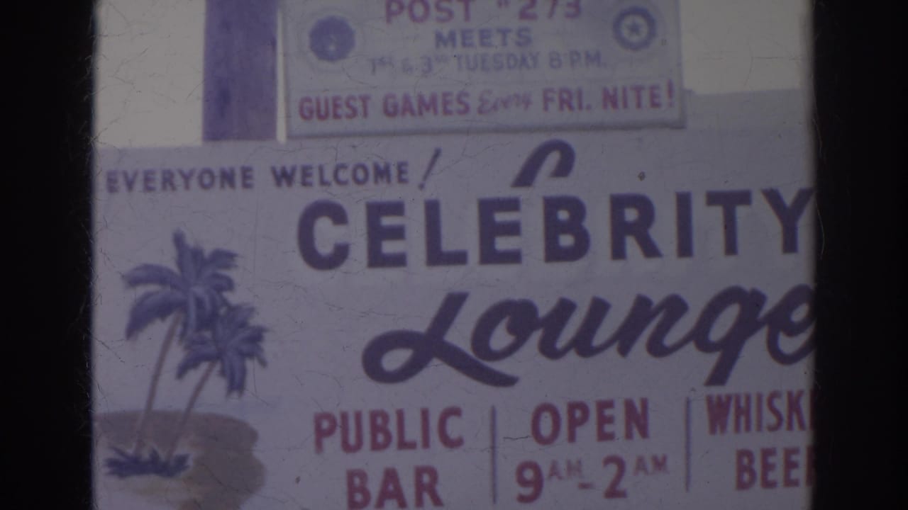 Close view of a Celebrity Lounge sign with public bar, hours, whiskey and beer text.