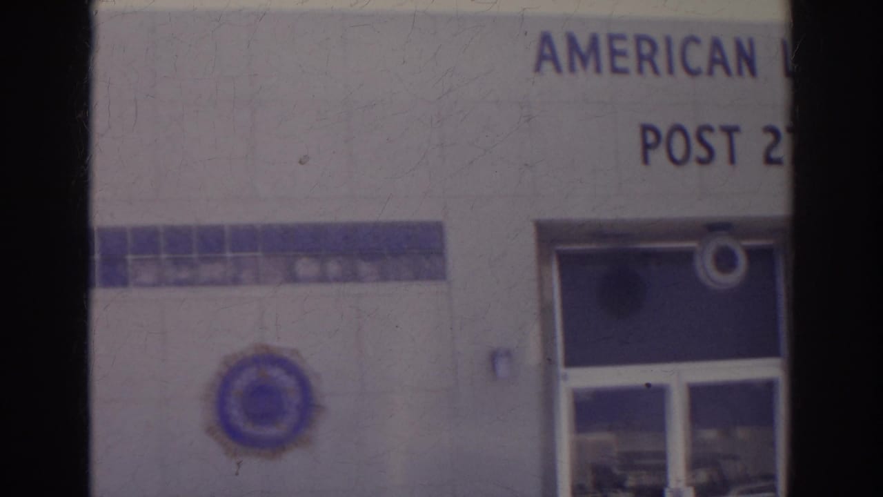 1966 Norfolk frame showing the lower American Legion Post 273 facade, including partial lettering, emblem, and recessed glass doors.