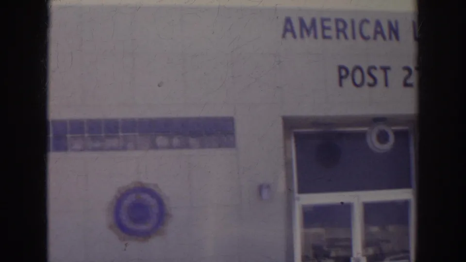 1966 Norfolk frame showing the lower American Legion Post 273 facade, including partial lettering, emblem, and recessed glass doors.