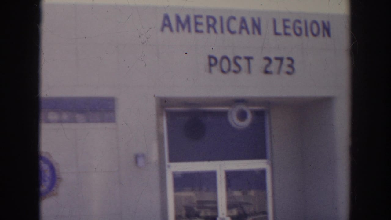 1966 Norfolk frame with American Legion Post 273 signage centered above the glass entrance and blue tile accents.