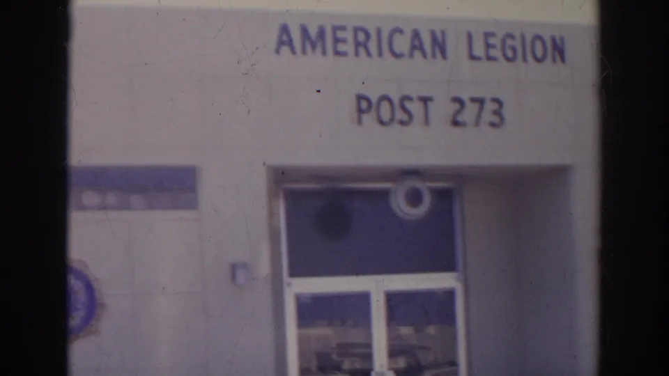 1966 Norfolk frame with American Legion Post 273 signage centered above the glass entrance and blue tile accents.