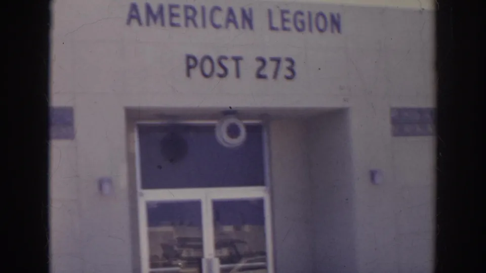 1966 Norfolk frame showing the American Legion Post 273 entrance, glass doors, and partial wall signage.