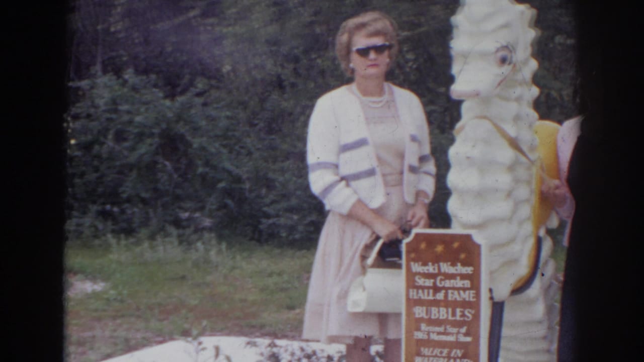 In 1966 Norfolk home-movie footage, a woman stands next to a white seahorse statue and Weeki Wachee Star Garden Hall of Fame sign.