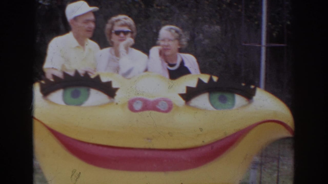 The 1966 Norfolk shot holds on three adults behind the oversized yellow smiling sculpture with painted eyes.