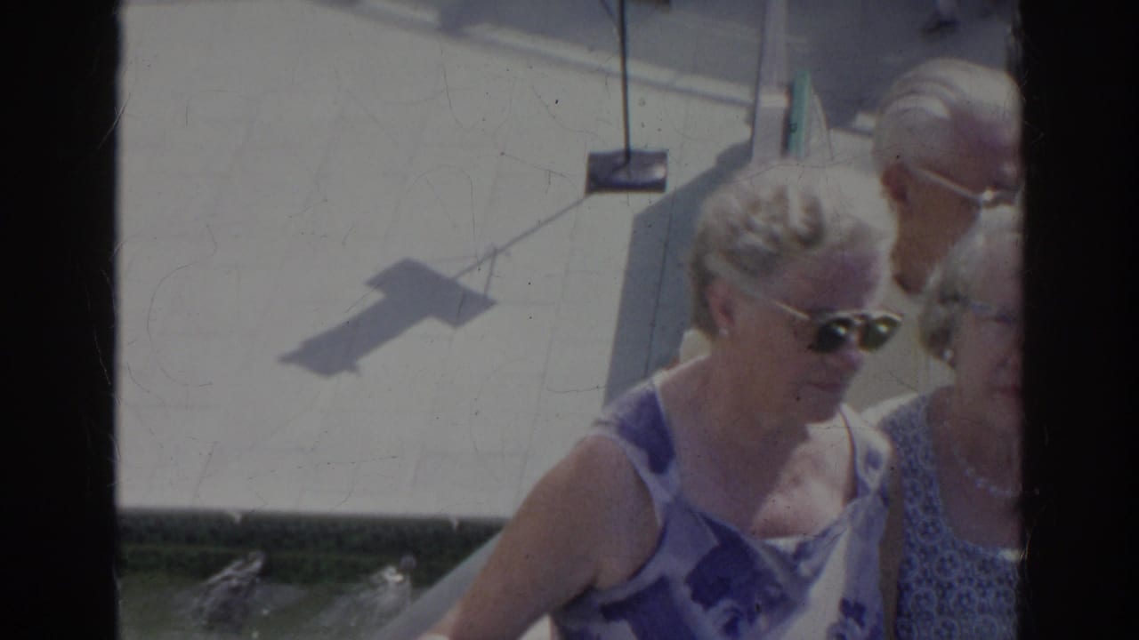 Older women in patterned summer clothing walk together outdoors in Norfolk, Virginia, captured in soft, faded 8mm color.