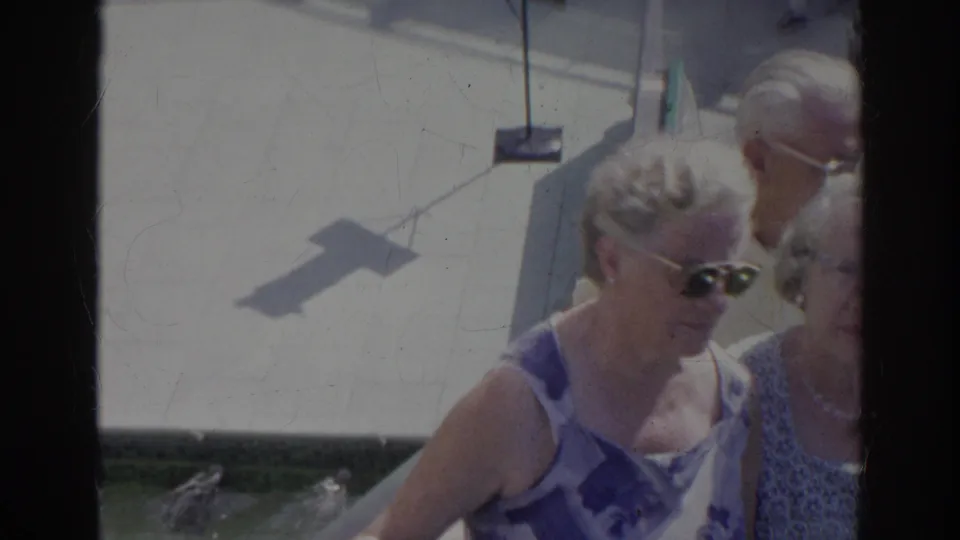 Older women in patterned summer clothing walk together outdoors in Norfolk, Virginia, captured in soft, faded 8mm color.