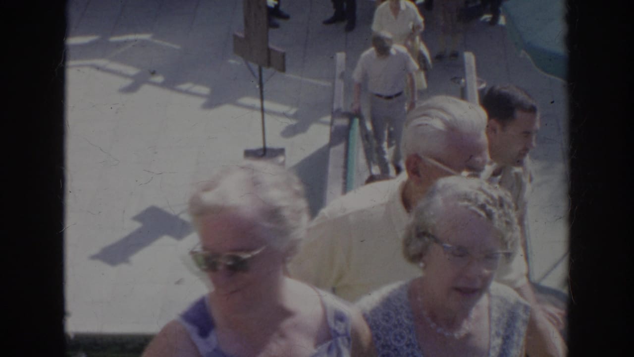 Older adults ascending outdoor concrete steps in bright sun.