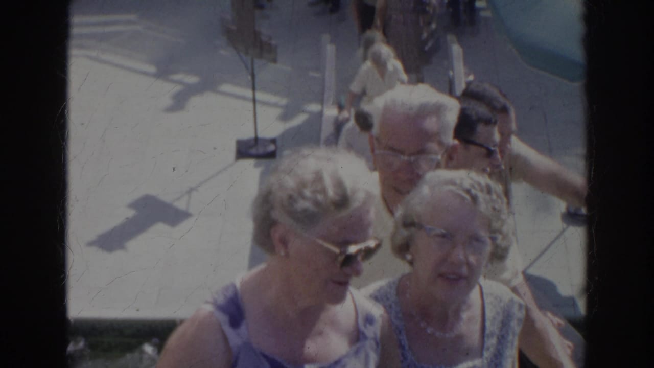 Two older women in summer dresses and sunglasses are seen close to camera on a sunlit Norfolk stairway in 1966.