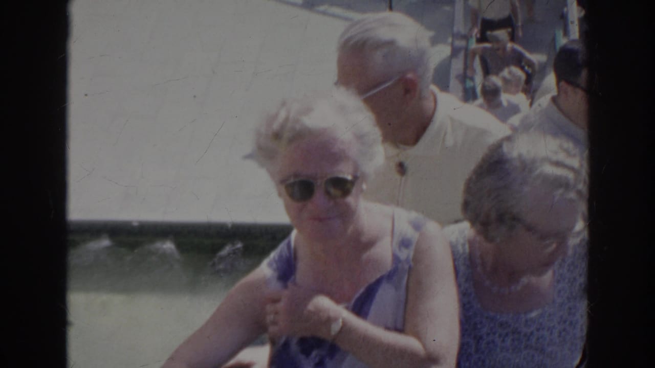 Near the end of the Norfolk 1966 clip, two older women and a man in a light shirt pass close to camera on the stairway.
