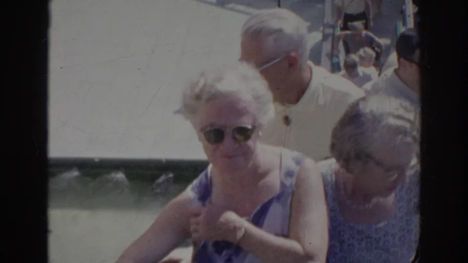 Near the end of the Norfolk 1966 clip, two older women and a man in a light shirt pass close to camera on the stairway.