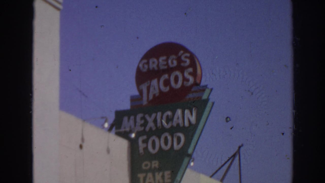 1966 San Gabriel frame centered on a tall Greg's Tacos Mexican food or take-out sign beside a storefront edge.