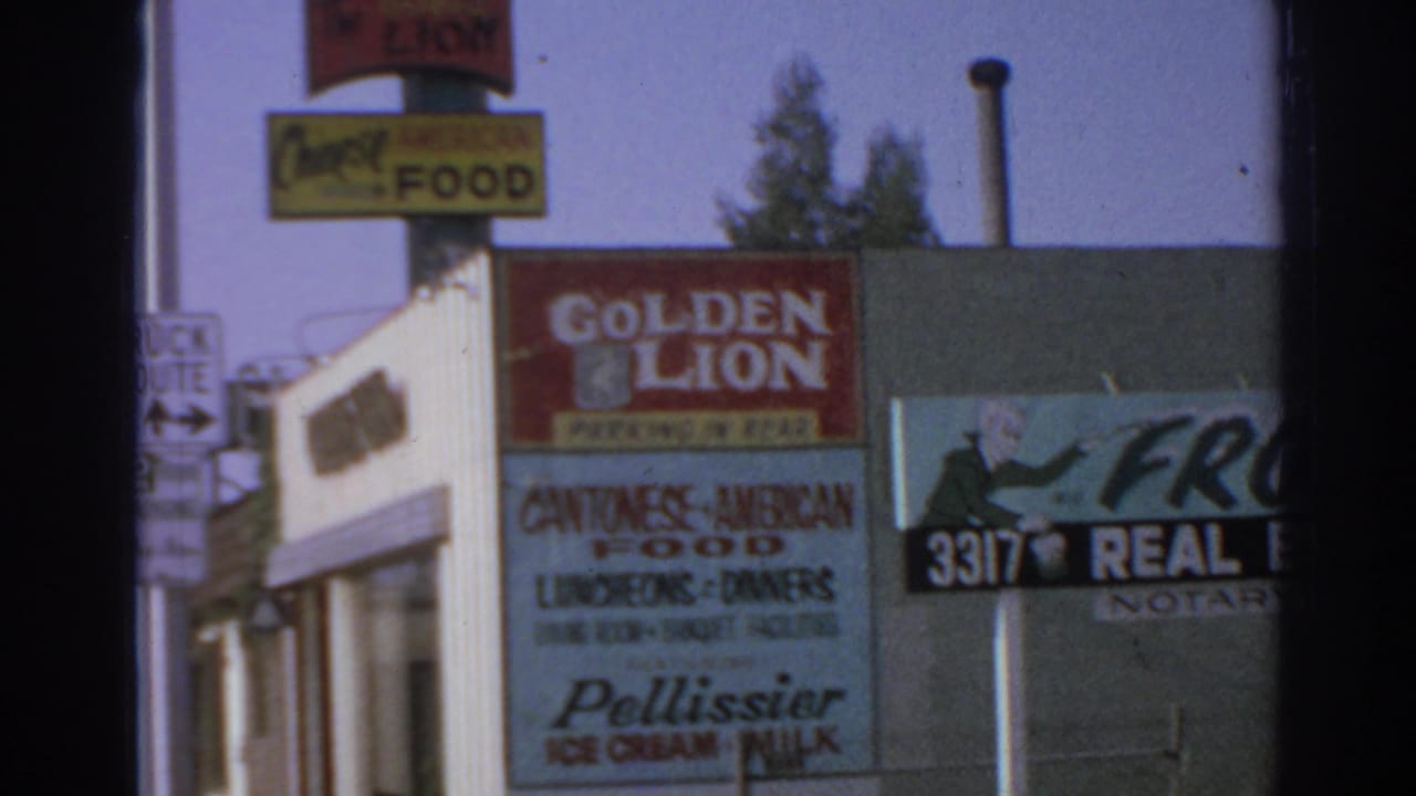 1966 San Gabriel street corner with Golden Lion restaurant signage, Cantonese-American food lettering, and a Frost Real Estate sign.