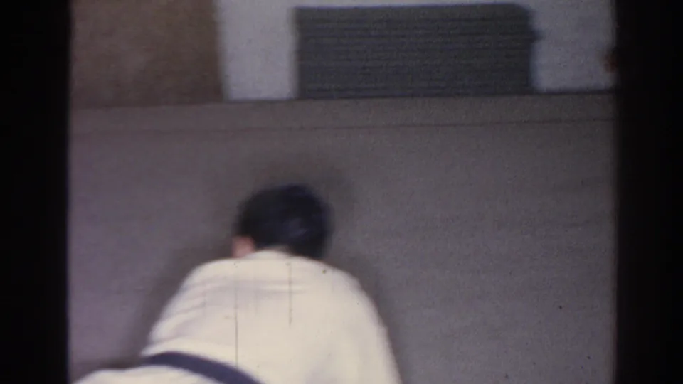 The final San Gabriel 1966 frame shows a martial arts student from behind near a wall vent in the indoor training room.