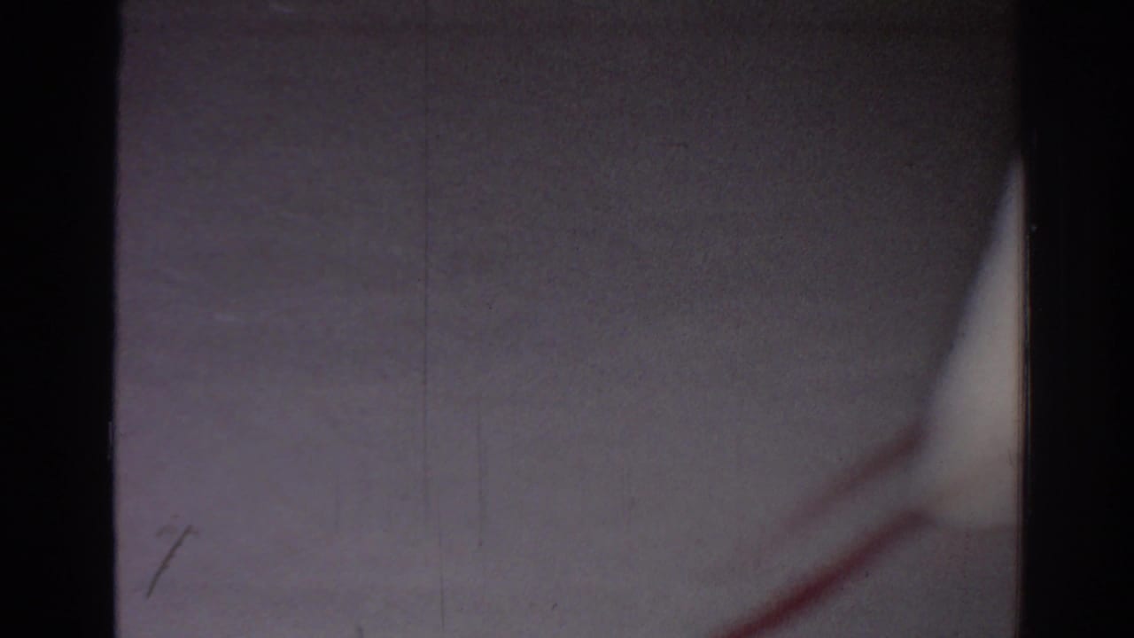 Soft 8mm frame of the gym mat area, with a red line and only partial blurred movement visible.