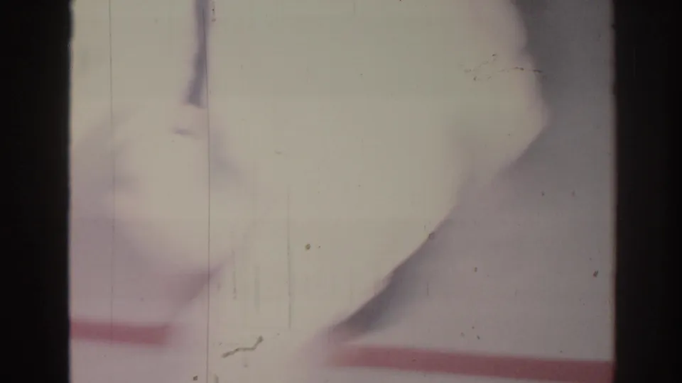 1966 home-movie frame with a white gi moving close to camera over a marked mat in San Gabriel.