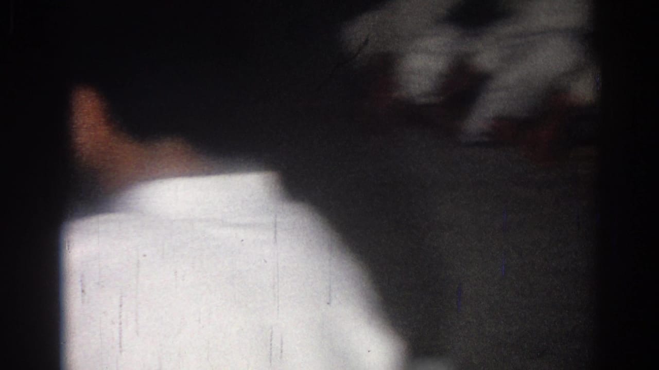 1966 San Gabriel frame with a judo participant seen from behind, facing a dim wall or training area.