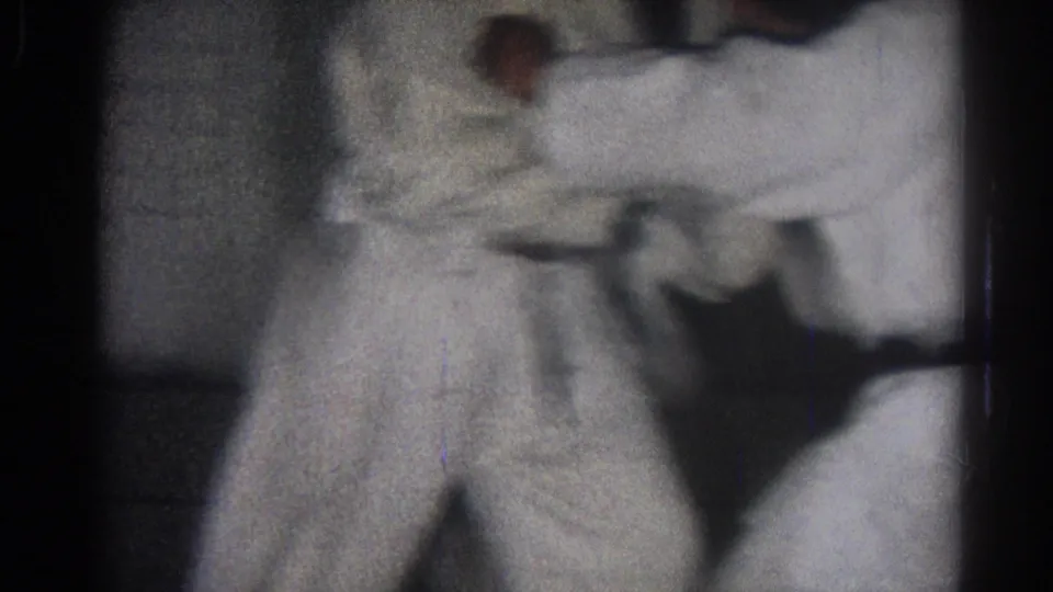 In the final frame, two white-uniformed practitioners are partially visible in a close indoor martial arts movement.