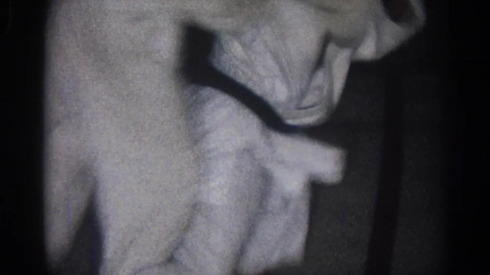 Two judo practitioners in white gi lean into a close hold in this low-light 1966 San Gabriel practice frame.