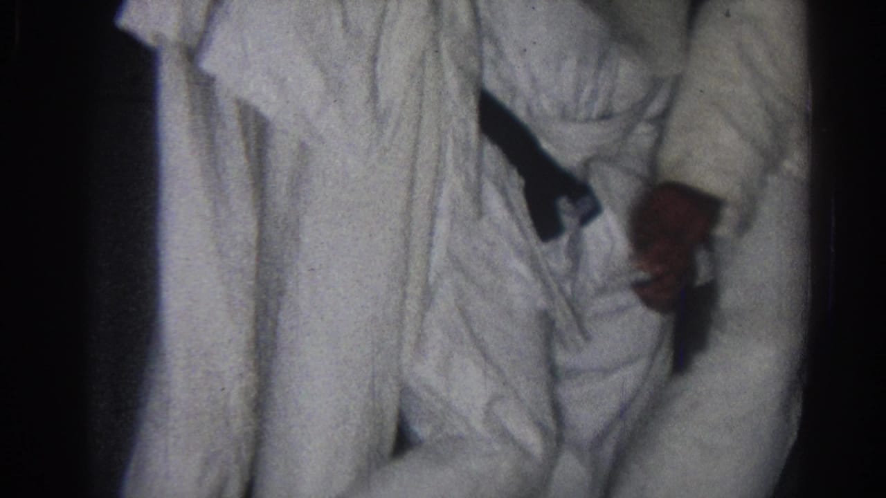 1966 San Gabriel frame with two white-uniformed martial arts participants partly visible during a close hold.