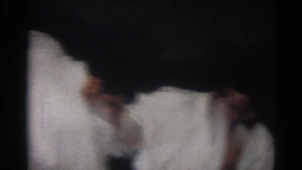 1966 San Gabriel 8mm frame with a dark, close view of two martial arts participants grappling near the floor.