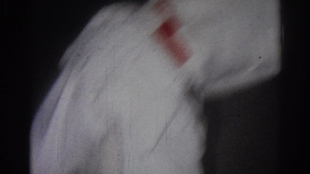 San Gabriel 1966 frame with a white-robed martial arts practitioner moving through a close, dimly lit shot.