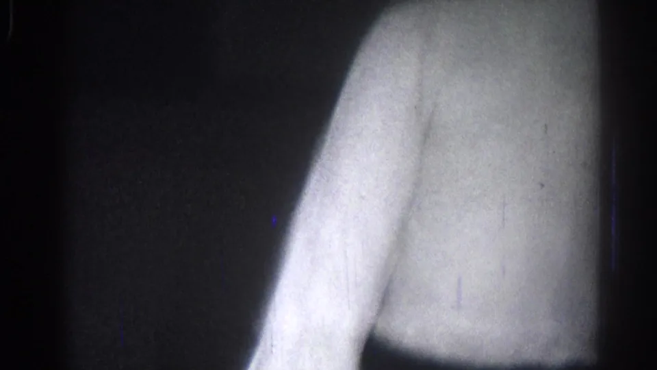 San Gabriel 1966 home-movie frame showing a close, motion-blurred view of martial arts practice in a white robe.