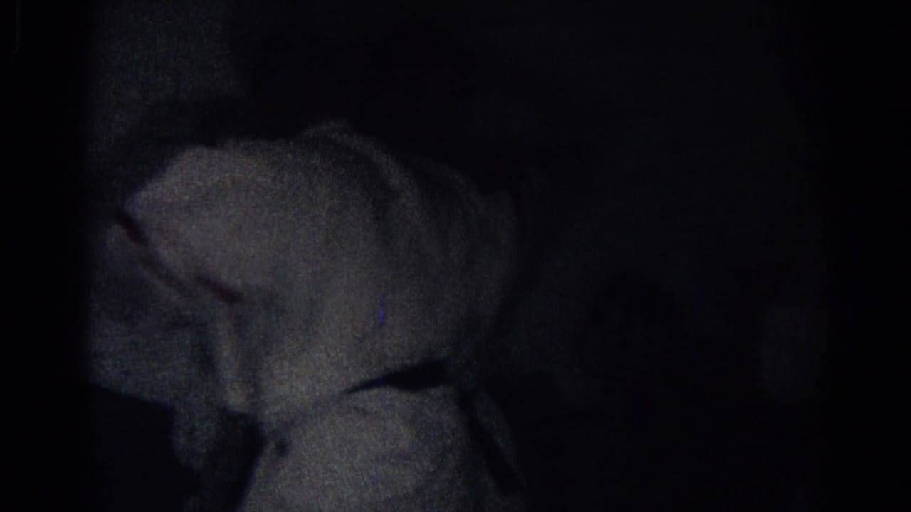 A white-uniformed karate practitioner appears in deep shadow in this 1966 San Gabriel home-movie frame.