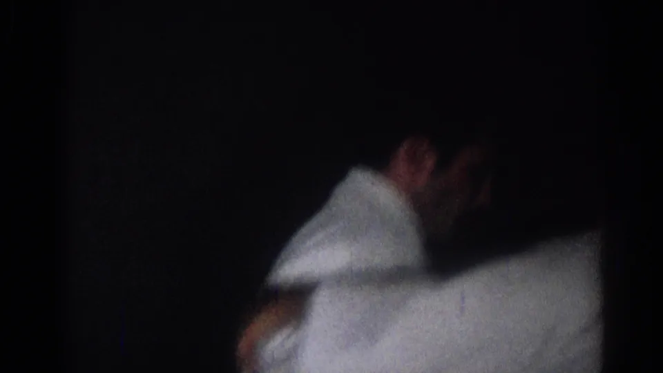 Two karate practitioners in white uniforms are partly seen in a shadowed 1966 San Gabriel indoor frame.