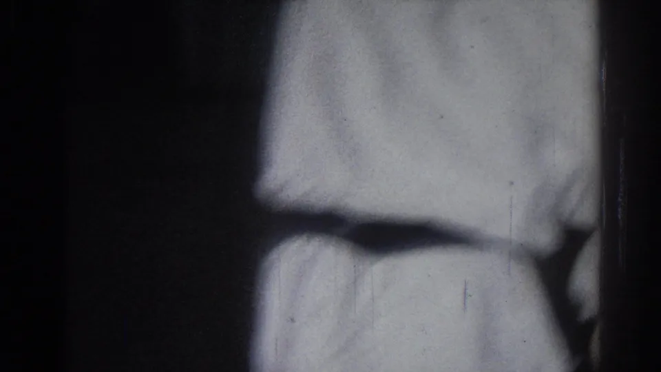 Close 8mm view of a martial arts uniform during the 1966 San Gabriel sparring class, with body detail cropped by the camera.