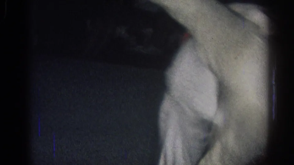 Dim 1966 home-movie frame from San Gabriel showing a white-clad judo practitioner moving on the training mat.