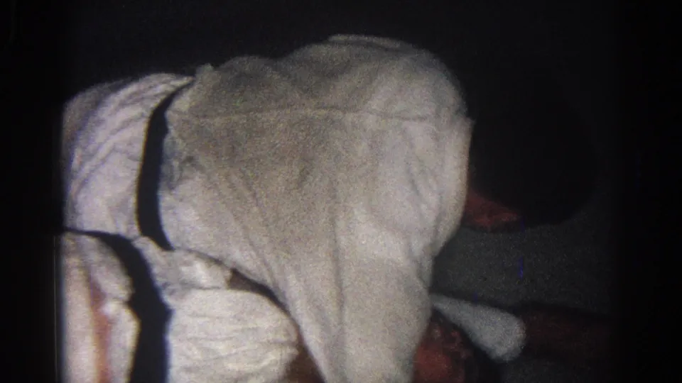 One white-uniformed practitioner bends over another during close ground sparring in the 1966 San Gabriel clip.