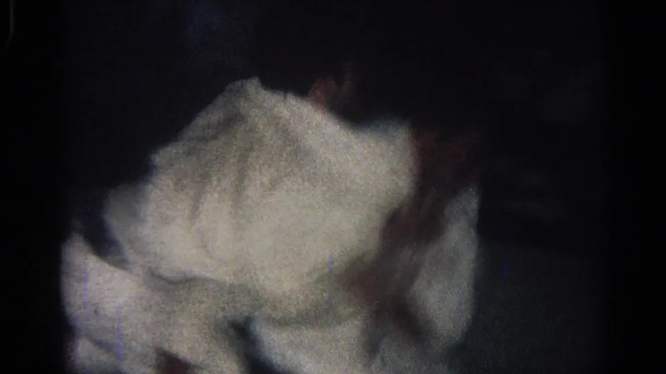 1966 San Gabriel frame showing close, blurred judo grappling in white gis against a dark indoor mat background.