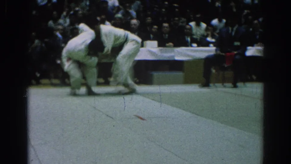 Near the end of the 1966 San Gabriel clip, one judo competitor appears to lift or turn the other during a close-range throw attempt.
