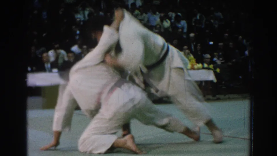 During the San Gabriel martial arts contest, one man appears to be taken down while the other remains over him on the mat.