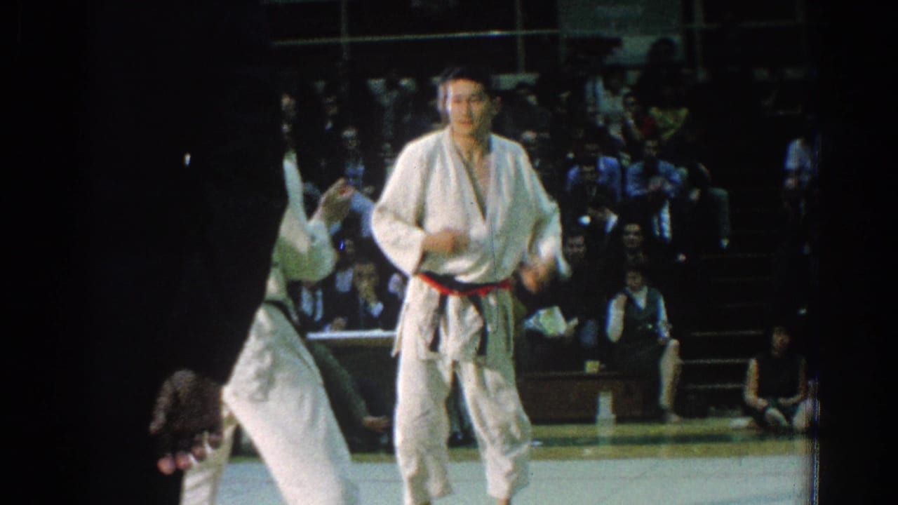 A 1966 San Gabriel judo exchange shows one competitor upright as another is thrown or lifted near a dark-clothed official.