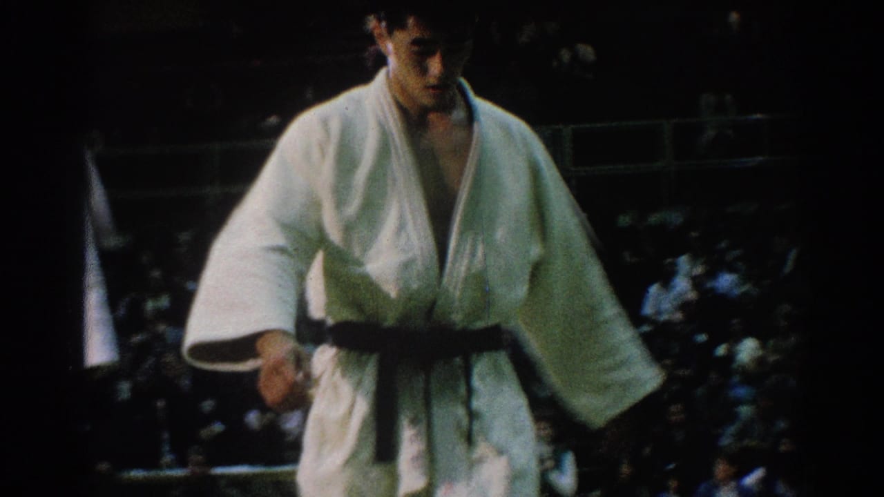 Young competitor in a white gi and black belt at an indoor martial arts contest in San Gabriel, California, 1966.