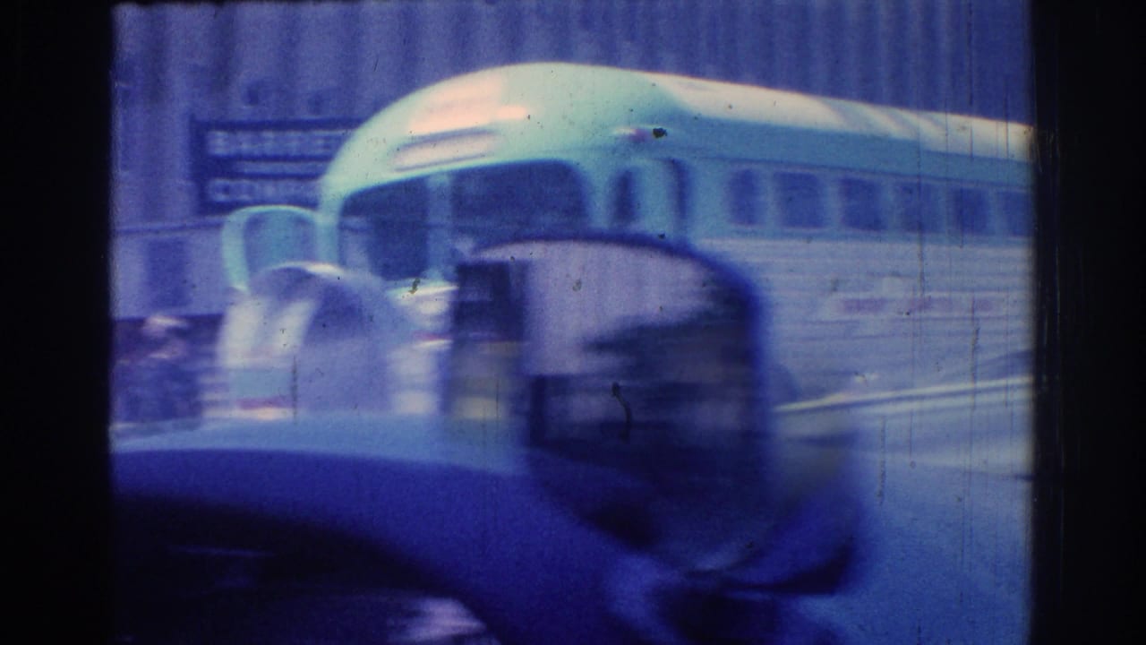 1966 San Gabriel street view with a light-colored bus passing through traffic, partly obscured by motion-blurred cars.