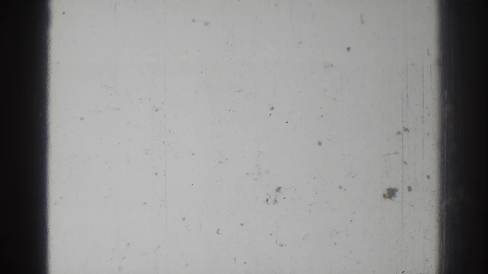 San Gabriel 1966 8mm reel frame showing a blank exposed surface, central dark frame band, dust specks, and faint scratches.