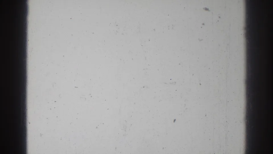 Blank or overexposed 8mm frame from the 1966 San Gabriel clip, showing film borders, dust, and surface wear but no clear subject.