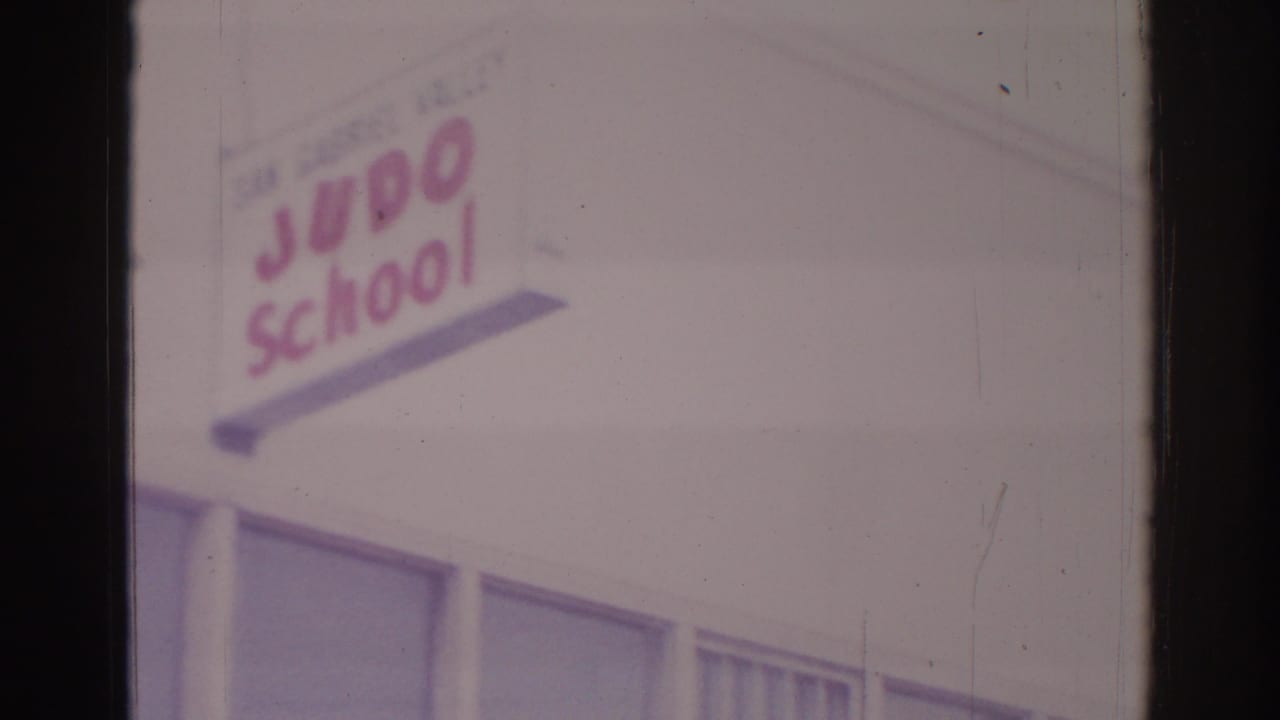 Judo school sign above windows on a building exterior.