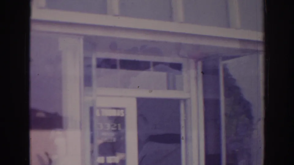 Temple City judo school exterior showing the entrance area, windows, and partially visible sign above in soft 8mm color.