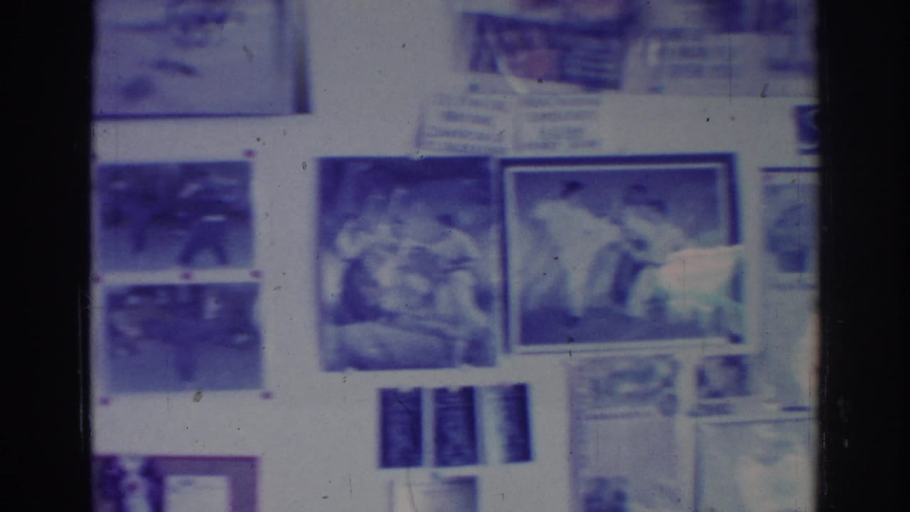 Wall display with framed martial arts photographs, posters, and notices under soft focus.