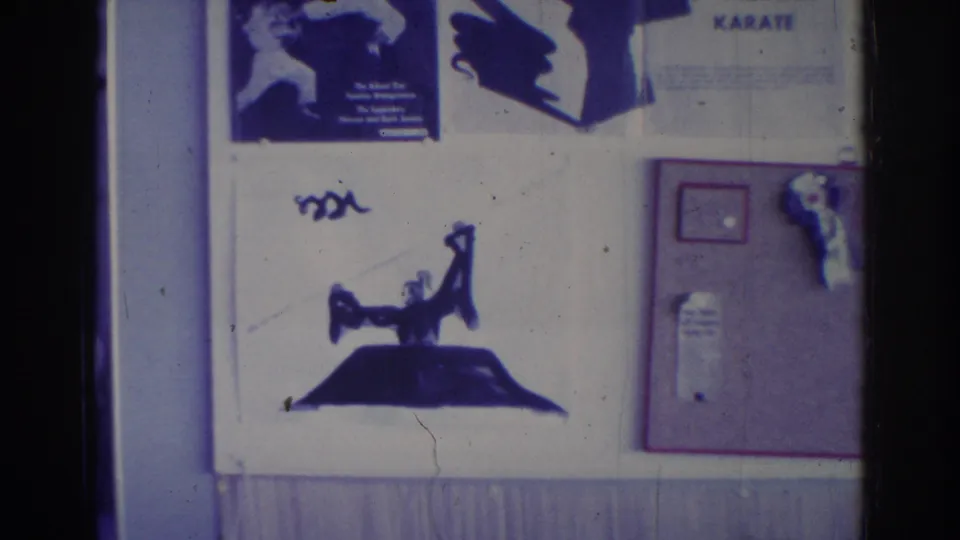 A Temple City martial arts school display includes a karate poster, graphic silhouette, framed notice, and posted material filmed in 1966.