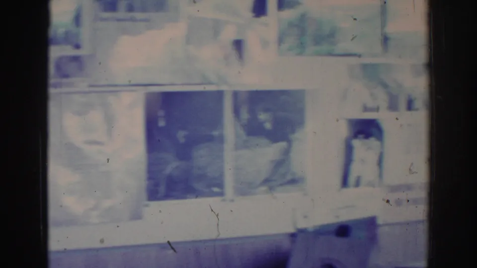 1966 8mm frame from Temple City footage showing an overexposed, color-shifted view of an interior before the martial arts action is clear.