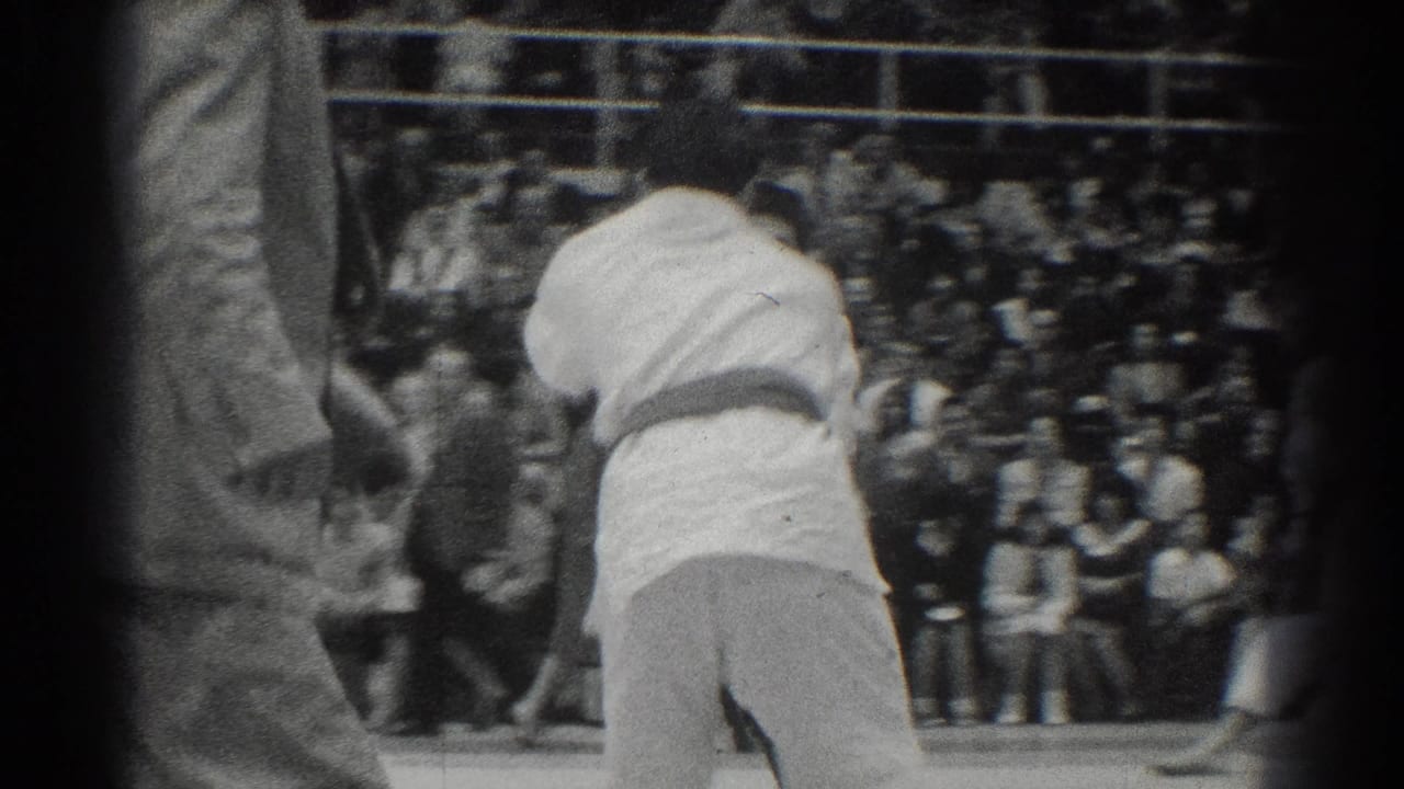 1966 West Covina karate competition footage showing two competitors in white gi engaged before a crowded set of bleachers.
